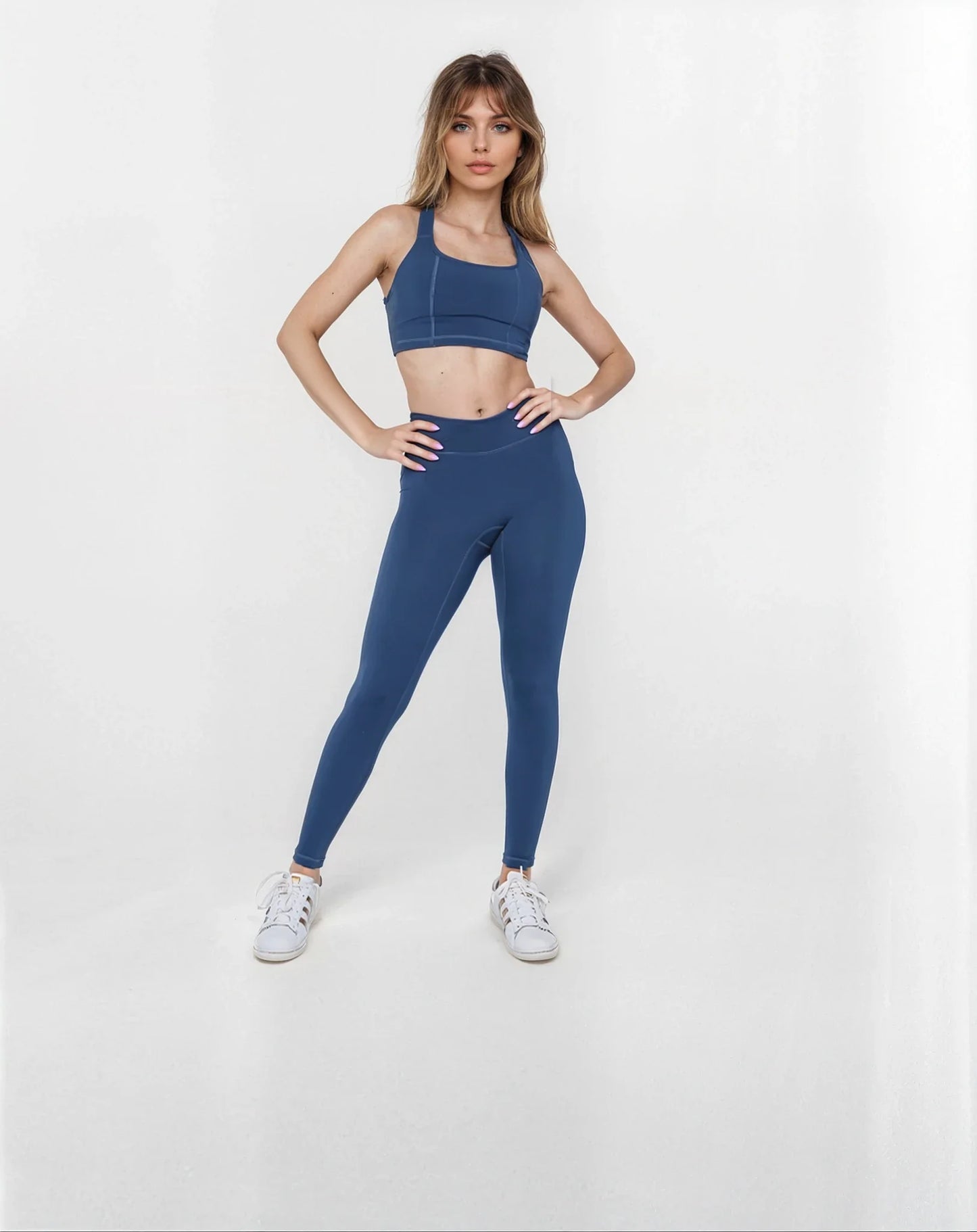 AutumnDiLullo wearing black SmoothFit Crossover Leggings by Fitkitty Culture, showcasing their high-waisted design and flexible fit.