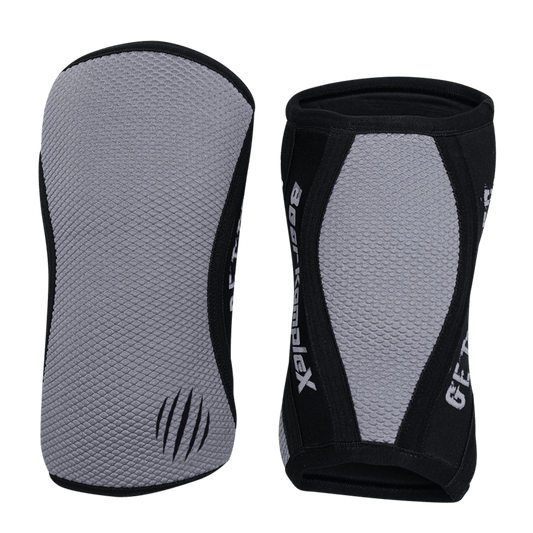 Gray Sharkskin Bear KompleX knee sleeves shown on a model, designed for support and compression during workouts.