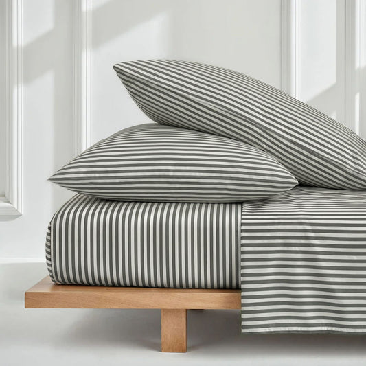 Luxurious Australian sateen sheet set from Italic with smooth, shiny fabric, neatly arranged on a bed with pillows.