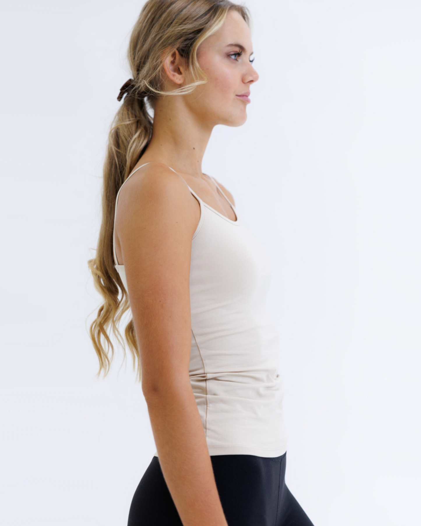 Downeast Wonder Cami in nude color, a comfortable fitted tee with soft fabric and sleeveless design, perfect for layering.