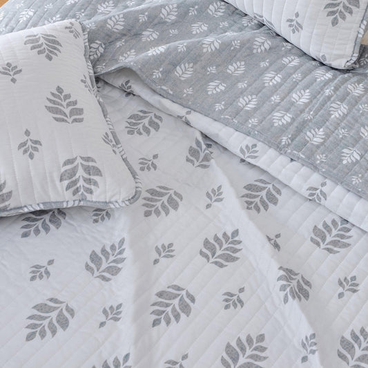 French floral quilt from Great Bay Home's Colette Collection, showcasing a soft, floral pattern on a cozy bedding quilt.