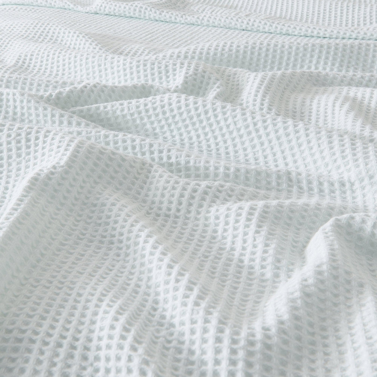 Soft 100% cotton waffle weave blanket from the Mikala Collection by Great Bay Home, showcasing textured fabric and cozy design.