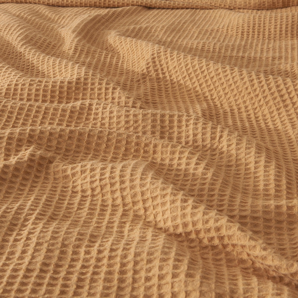 Cream-colored 100% cotton waffle weave blanket from the Mikala Collection by Great Bay Home, cozy and lightweight for bed or lounging.