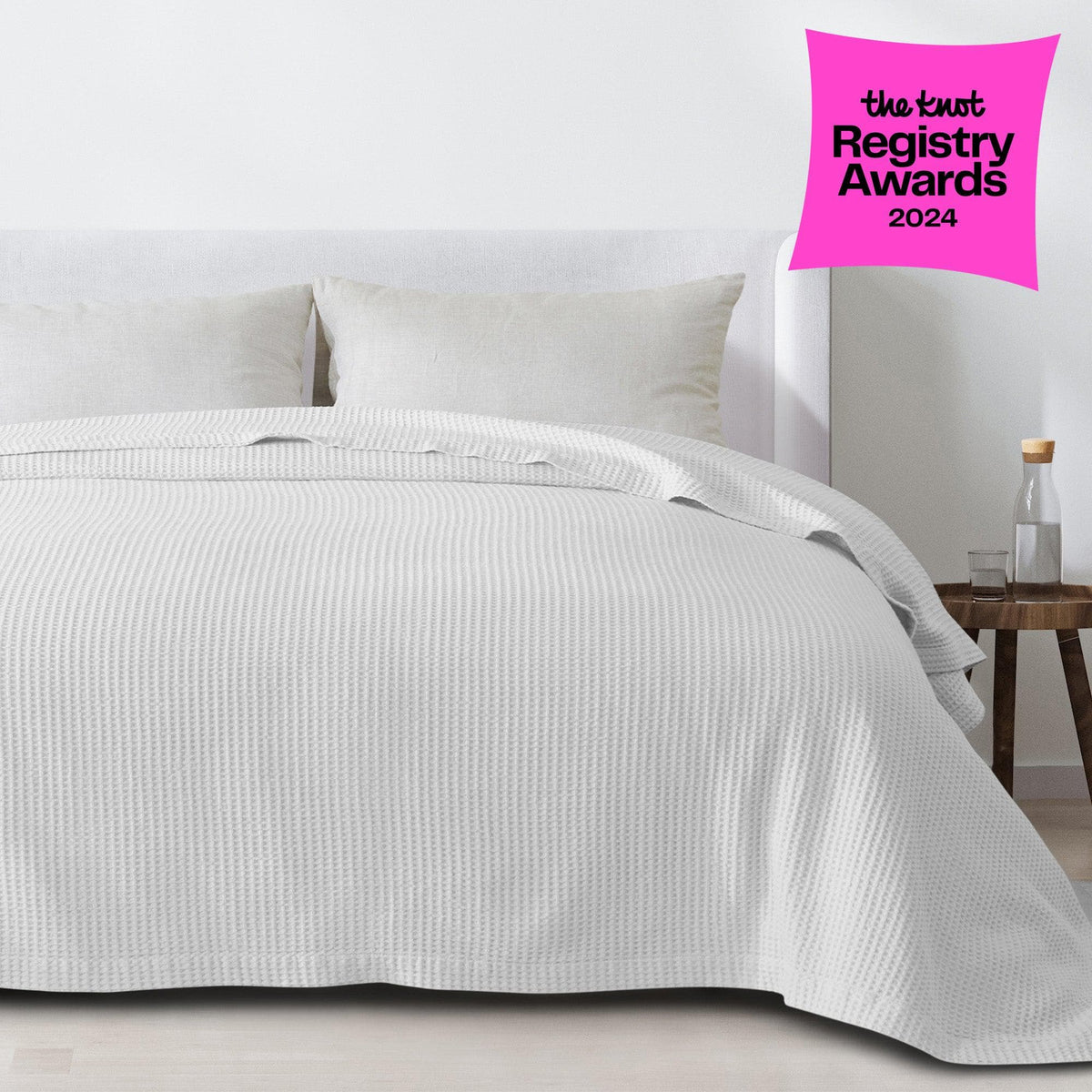 Cream-colored 100% cotton waffle weave blanket from the Mikala Collection by Great Bay Home, draped over a bed.