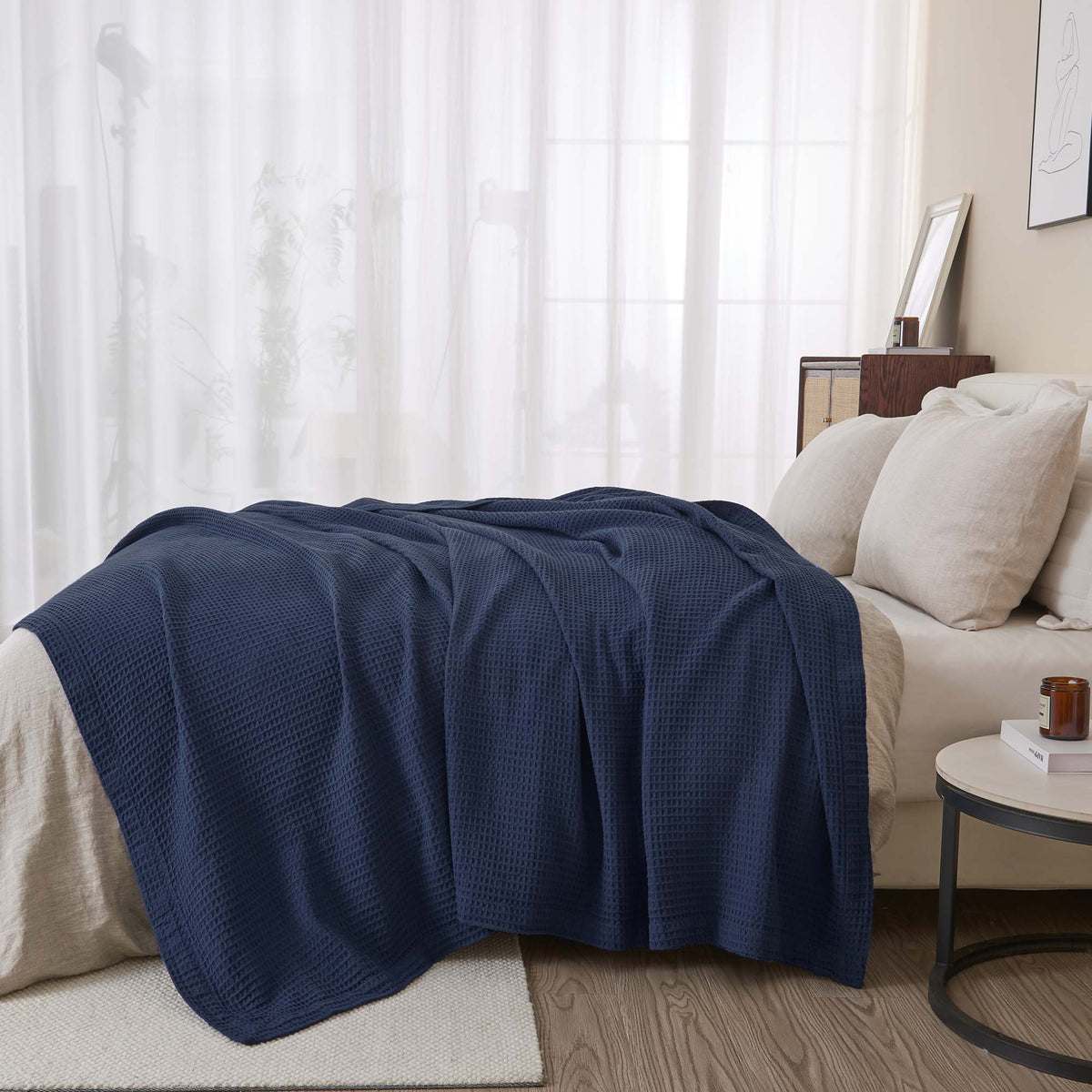 Cream-colored 100% cotton waffle weave blanket from the Mikala Collection by Great Bay Home, displayed folded on a bed.