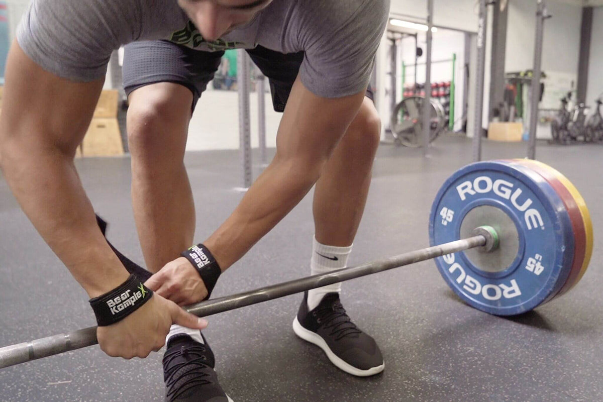 Pair of Bear KompleX lifting straps with padded wrist support, designed for weightlifting and strength training exercises.
