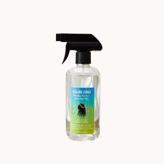 Rosemary and tea tree hydration mist by Flower Child Loc Care LLC, in a clear spray bottle with a leafy botanical design.