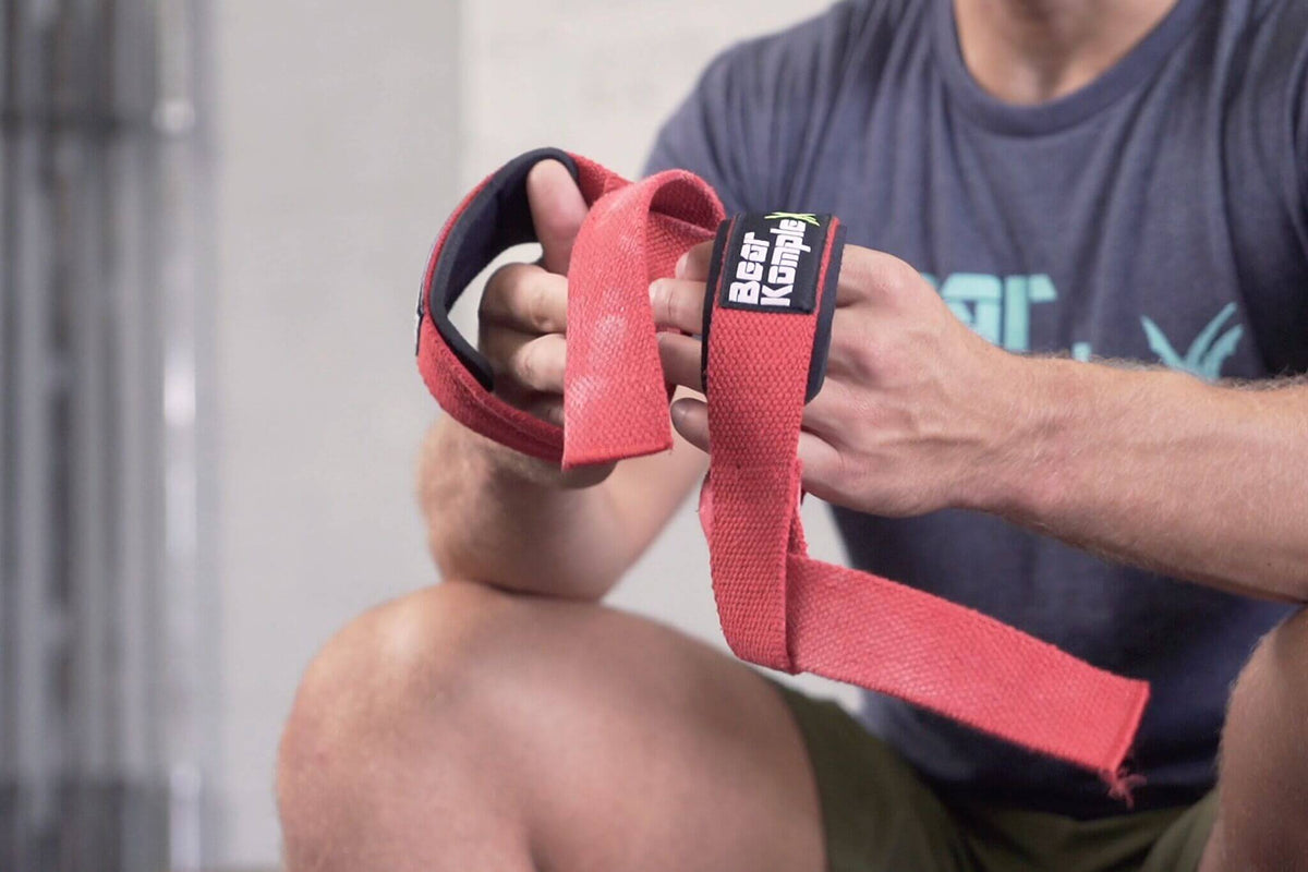 Pair of Bear KompleX lifting straps for weightlifting and strength training, made of durable material with padded grips.