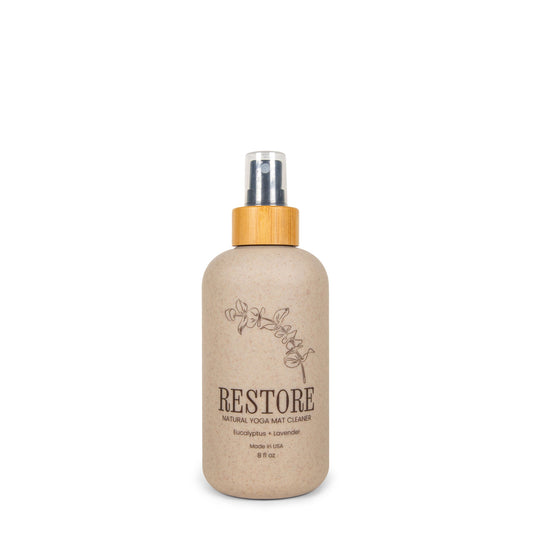 Yoloha Yoga 8oz Restore Yoga Mat Cleaner in a clear bottle, designed for all-purpose cleaning of yoga mats and exercise equipment.