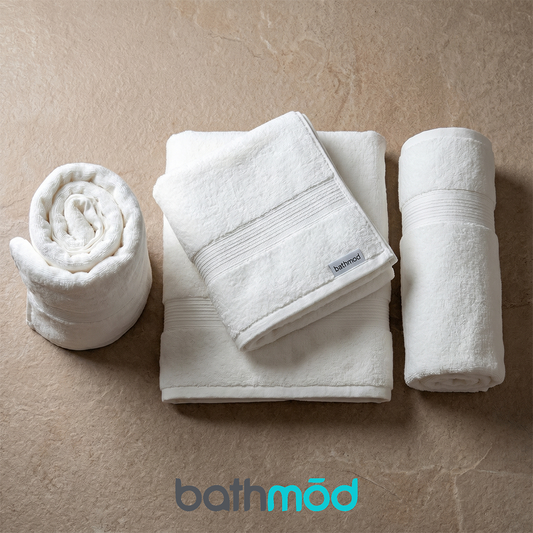 Set of four ecobrands® luxury organic bath towels with soft, plush texture and subtle abstract pattern in neutral tones.