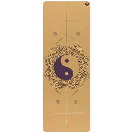 Yoloha Yoga Balance and Unity Aura cork yoga mat laid out on a wooden floor, showcasing its natural cork surface and textured design.