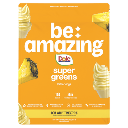 Be Amazing Super Greens powder in a container with a Dole Whip Pineapple flavor label, showcasing vibrant green supplement packaging.