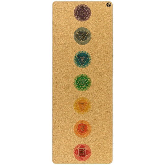 Yoloha Yoga Chakras Original Cork Yoga Mat laid out on a wooden floor, showcasing its textured cork surface and vibrant chakra design.