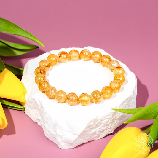 Golden Healer Quartz bracelet from Conscious Items featuring polished golden-colored beads and a stretch fit design.
