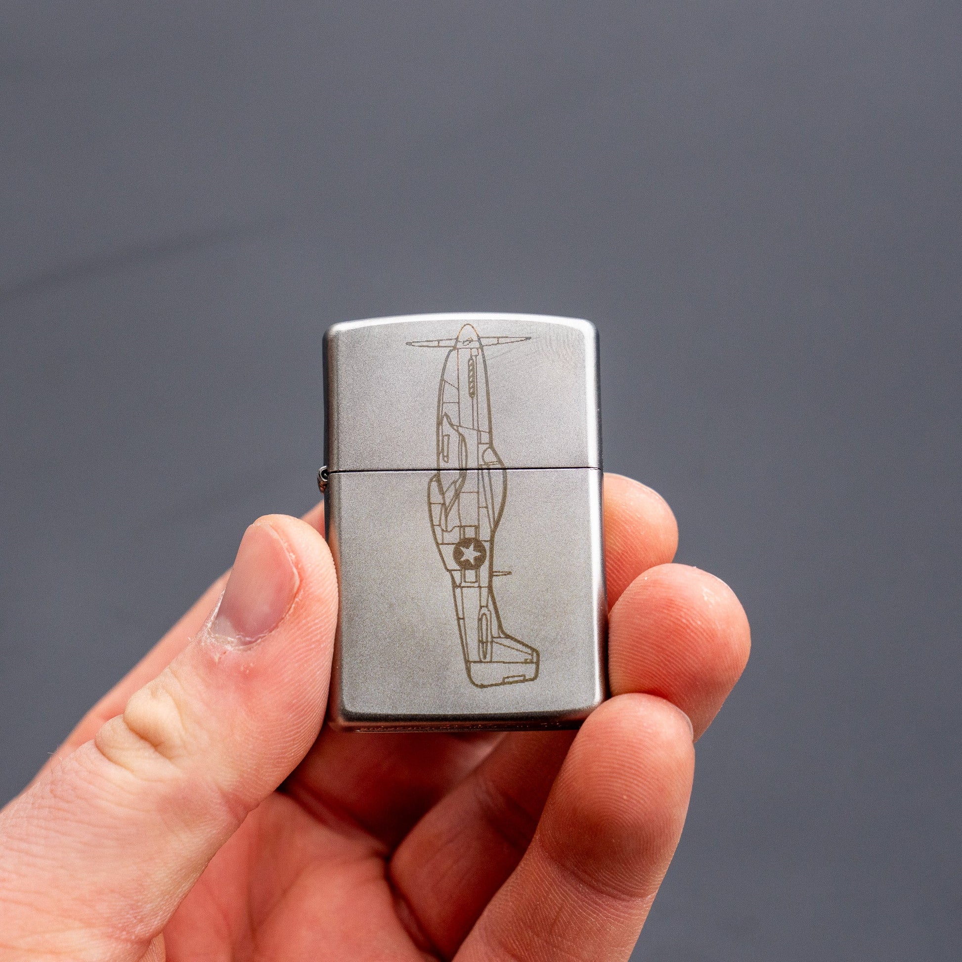 Americana Pipedream Apparel Zippo lighter with classic metal case, open lid showing the flame ignition mechanism.