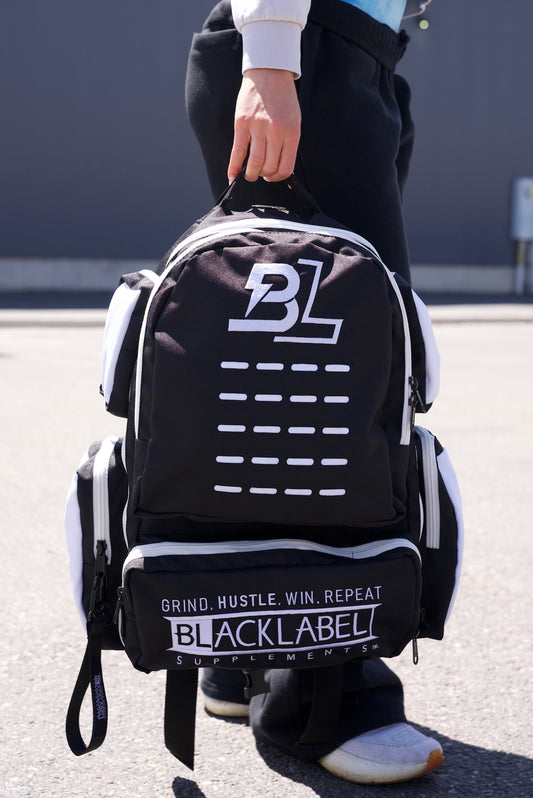 BlackLabel 26L backpack in black with multiple compartments, designed for travel and daily use, by BLACKLABEL Supplements.