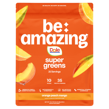 Be Amazing Super Greens juice with orange, peach, and mango in a clear glass bottle, showcasing vibrant fruit flavors.