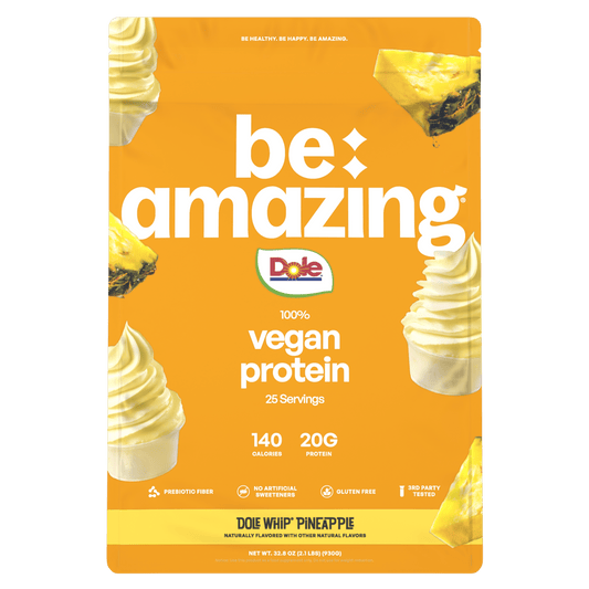 Be Amazing vegan protein powder in a pineapple Dole Whip flavor container, showing the label and product packaging.