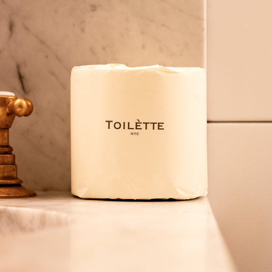 Toilette brand toilet paper rolls, soft and thick, stacked in a tidy pile, ready for bathroom use.