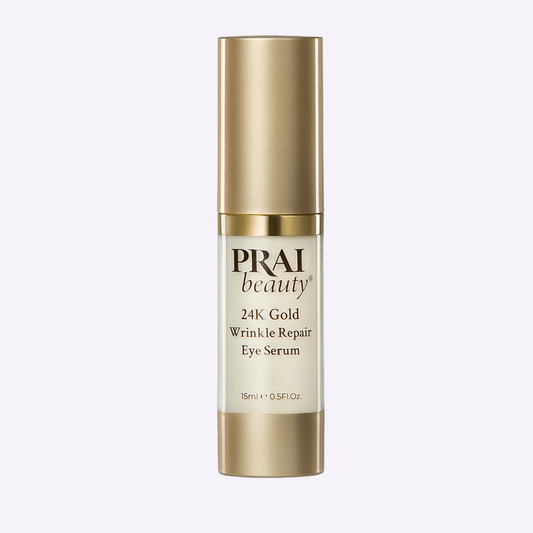 PRAI Beauty 24K Gold Wrinkle Repair Eye Serum in a 15ml bottle, featuring gold-infused formula for eye area care.