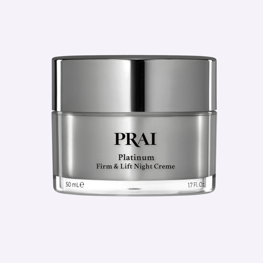 PRAI Beauty Platinum Firm & Lift Night Creme in a 50ml jar, showing the luxurious cream texture for overnight skin repair.