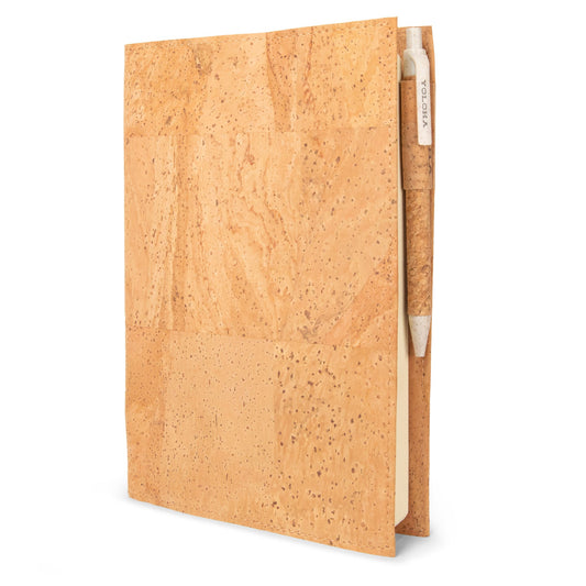 Refillable cork journal book by Yoloha Yoga with a textured cork cover and lined pages for writing and note-taking.