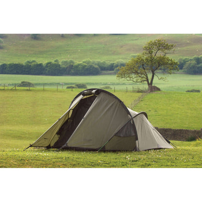 Snugpak Scorpion Tent set up outdoors, featuring durable fabric, ventilation, and spacious interior for camping adventures.