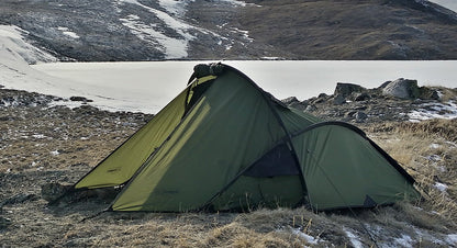 Snugpak Scorpion Tent set up outdoors, showcasing durable fabric, rainfly, and mesh windows for camping and outdoor adventures.