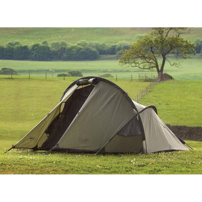 Snugpak Scorpion Tent by Americana Pipedream Apparel set up outdoors, showcasing its durable rainfly and spacious interior for camping.