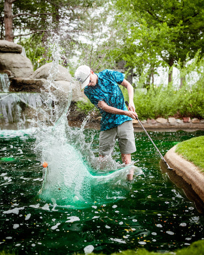 Men's Cabana Nights polo shirt by Pins and Aces featuring a tropical-inspired design and comfortable fit.