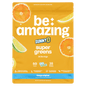 Bright image of Be Amazing Super Greens powder in a jar with a tangy orange flavor label, showcasing vibrant green powder inside.