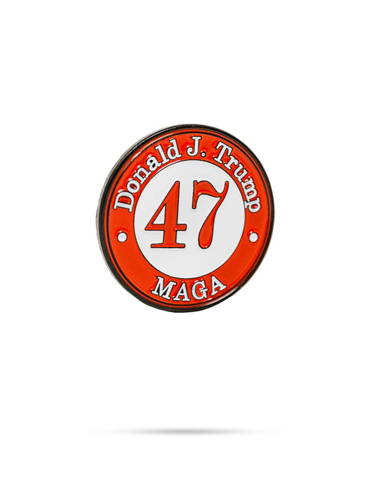 Pins and Aces Trump 47 golf ball marker with engraved design, compact accessory for marking golf balls on the green.