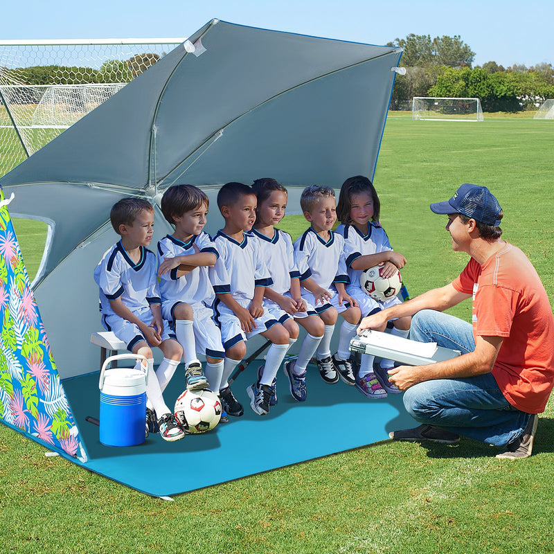 Blue UPF50+ sun protection beach umbrella tent by GemGear with portable carrying bag, providing shade at the beach.