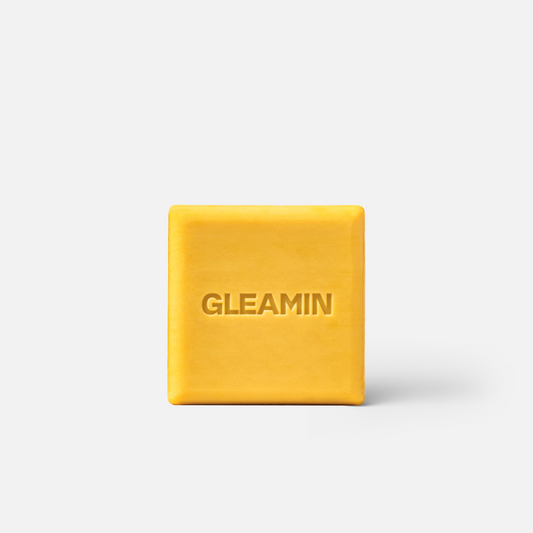 Gleamin Glow Body Bar brightening bar with a sleek container, designed to enhance skin radiance and smoothness.