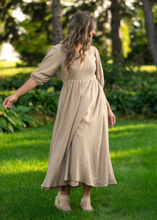 Inherit Co. Kayleen Tan smocked bodice gauze dress with flowing fabric and adjustable straps, ideal for casual or summer wear.