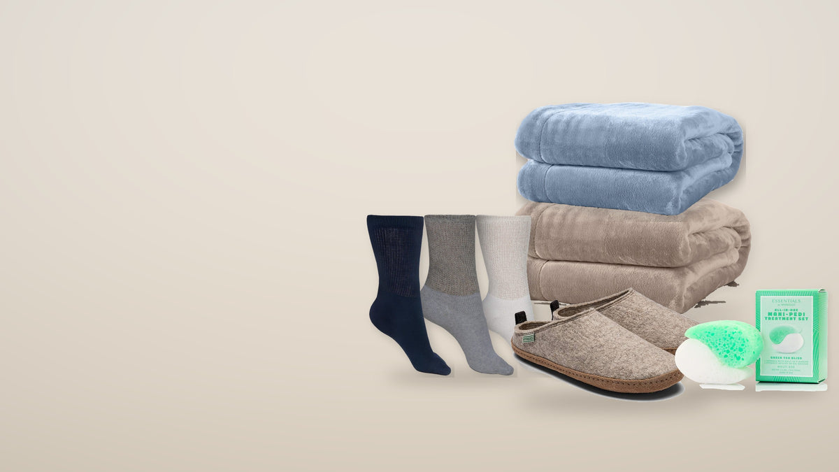 Folded plush blankets, crew socks, Kyrgies wool slides and Spongellé set