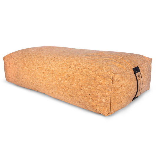 Natural cork bolster meditation cushion by Yoloha Yoga, showcasing the textured cork surface and supportive shape for meditation.