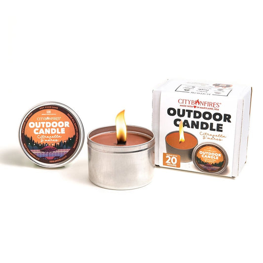 City Bonfires outdoor citronella candle with s'mores scent, shown in a cozy outdoor setting to repel insects.