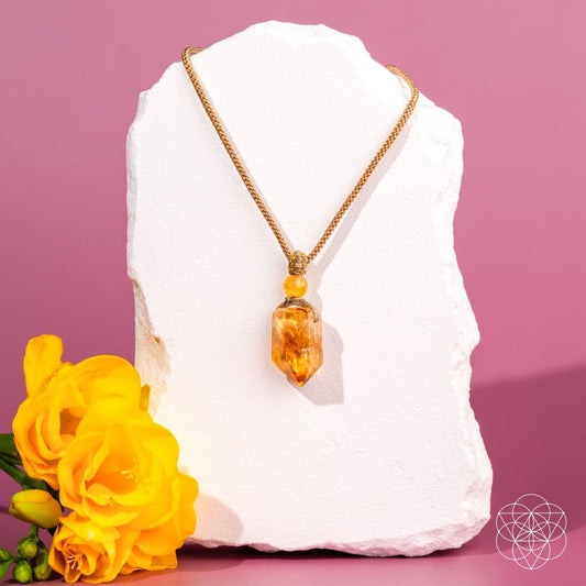 Gold charm pendant necklace featuring The Prosperity Pendant by Conscious Items, with intricate design and polished finish.